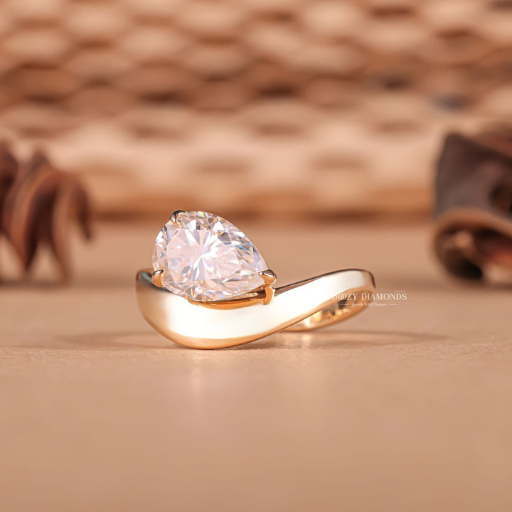 Lifestyle shot of pear dome diamond ring on hand