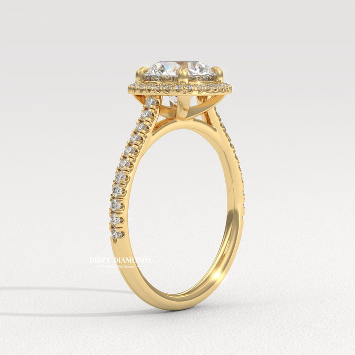 Close-up of round cut center diamond in halo engagement ring