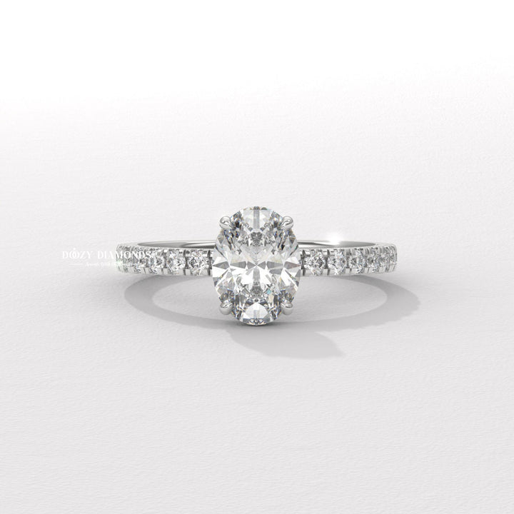 Oval hidden halo engagement ring finished in polished solid gold