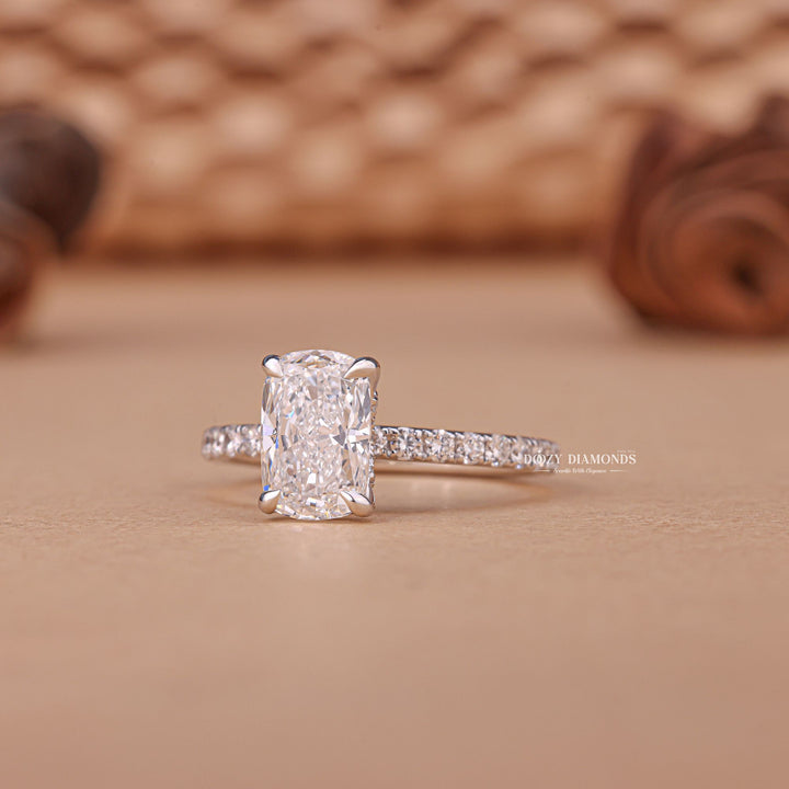 Cushion pave diamond ring displayed on jewelry stand