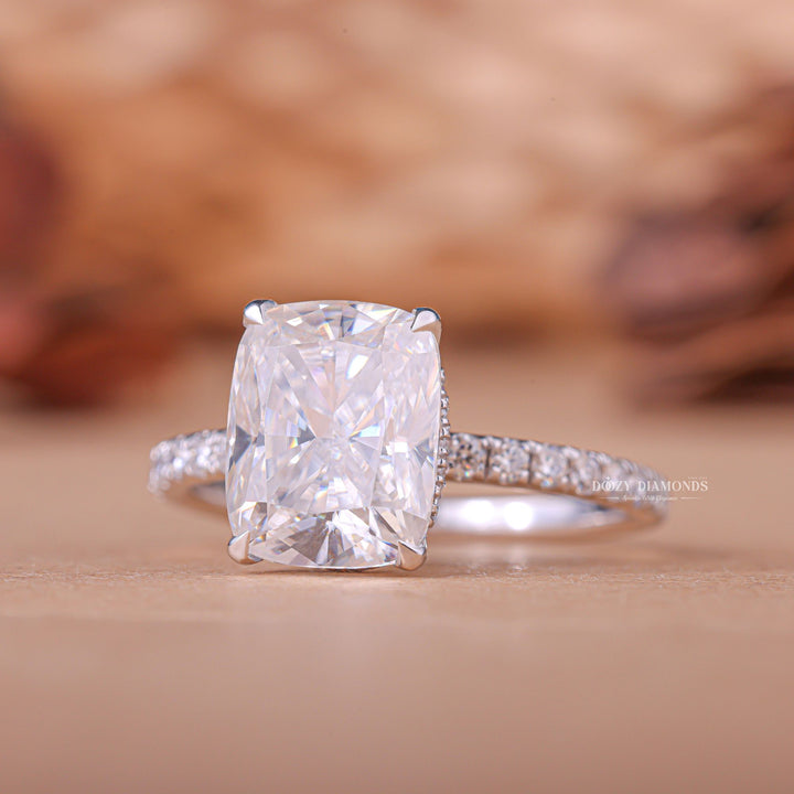 Cushion hidden halo engagement ring close-up showing E/VS1 diamond clarity