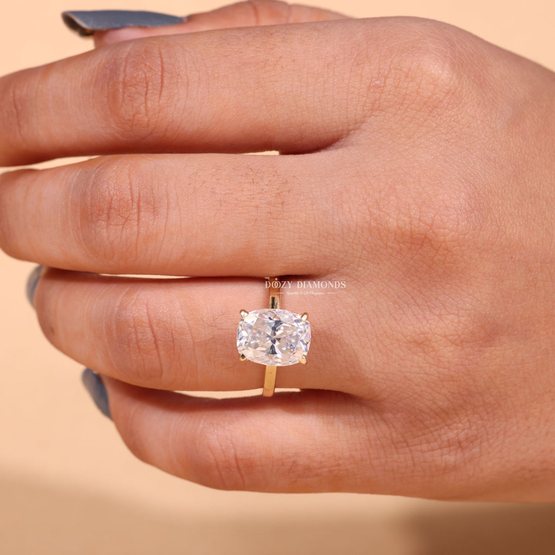 Cushion hidden halo engagement ring shown on hand for true-to-life sizing