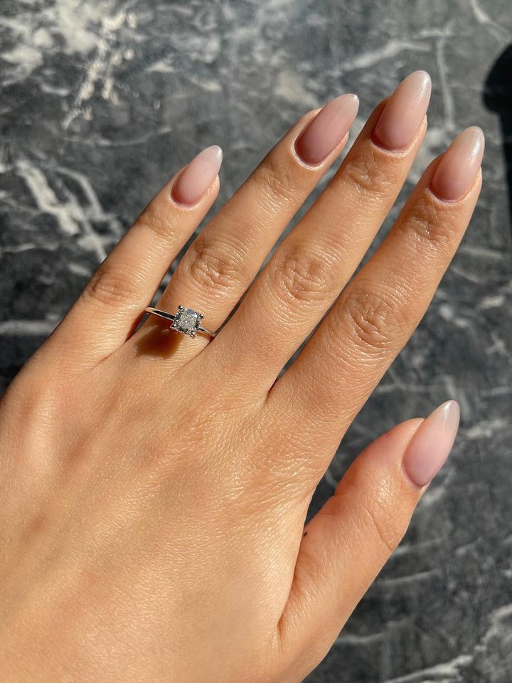 Lifestyle shot of cushion solitaire diamond ring on hand