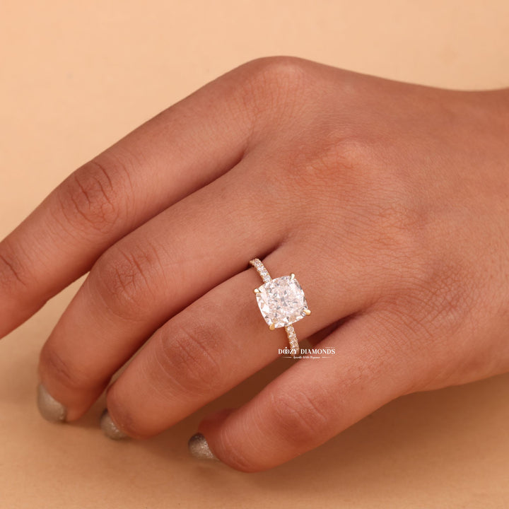 Cushion hidden halo lab grown diamond ring fitted on finger