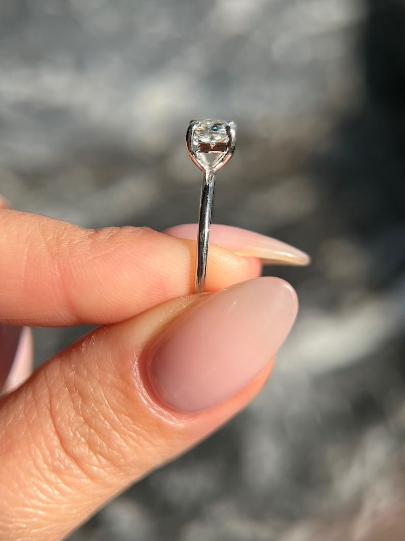Cushion cut diamond ring worn on hand