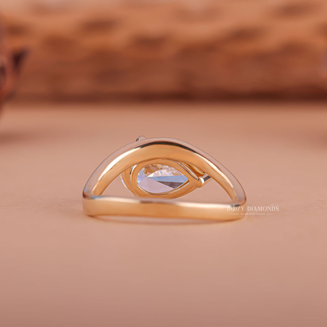 Top-down view of pear cut east west engagement ring