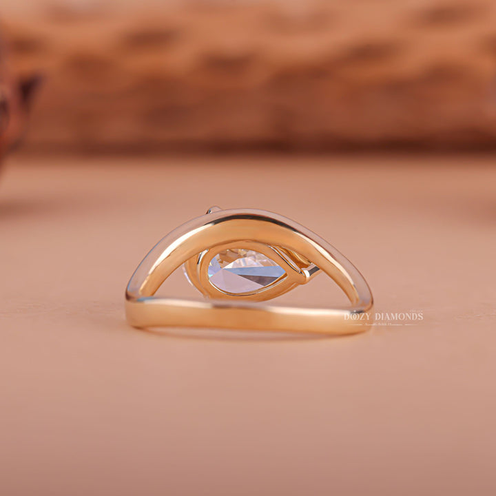 Top-down view of pear cut east west engagement ring