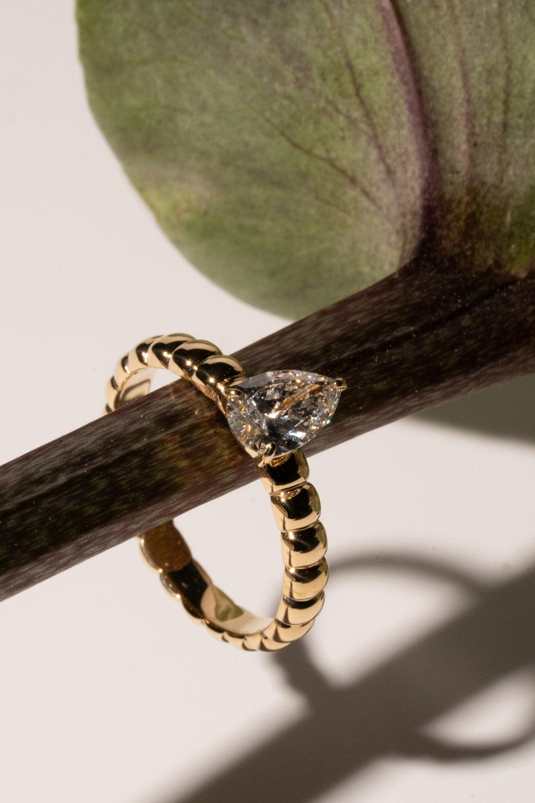 Pear solitaire lab grown diamond ring side profile in gold setting