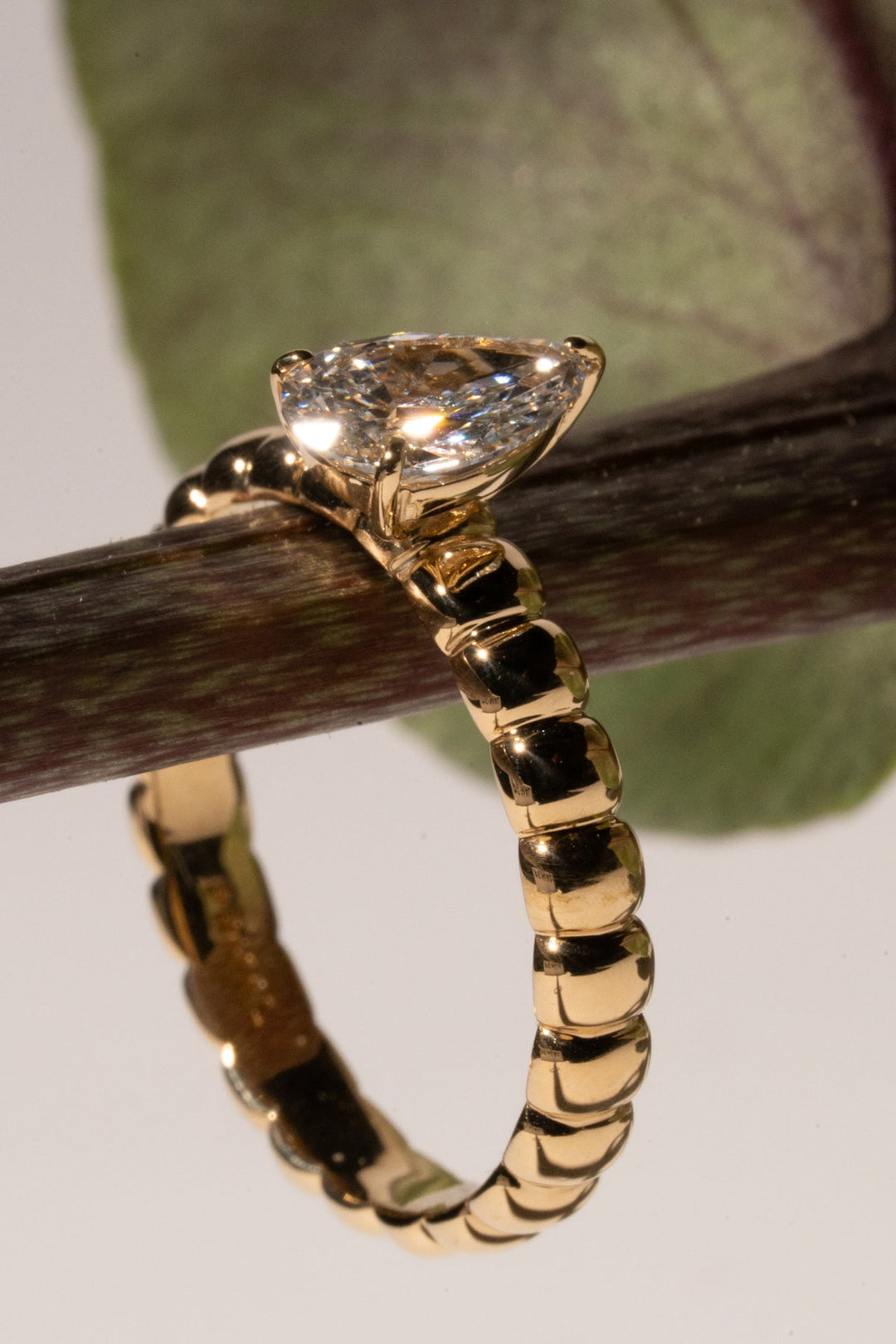 Pear cut engagement ring side view showing band detail