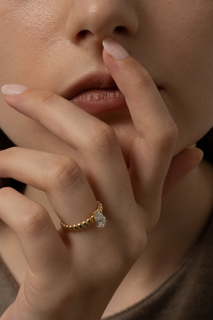 Pear solitaire engagement ring close-up showing high clarity diamond clarity