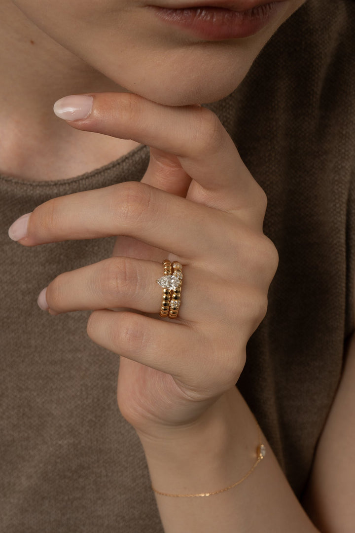 Close-up of pear cut center diamond in solitaire engagement ring