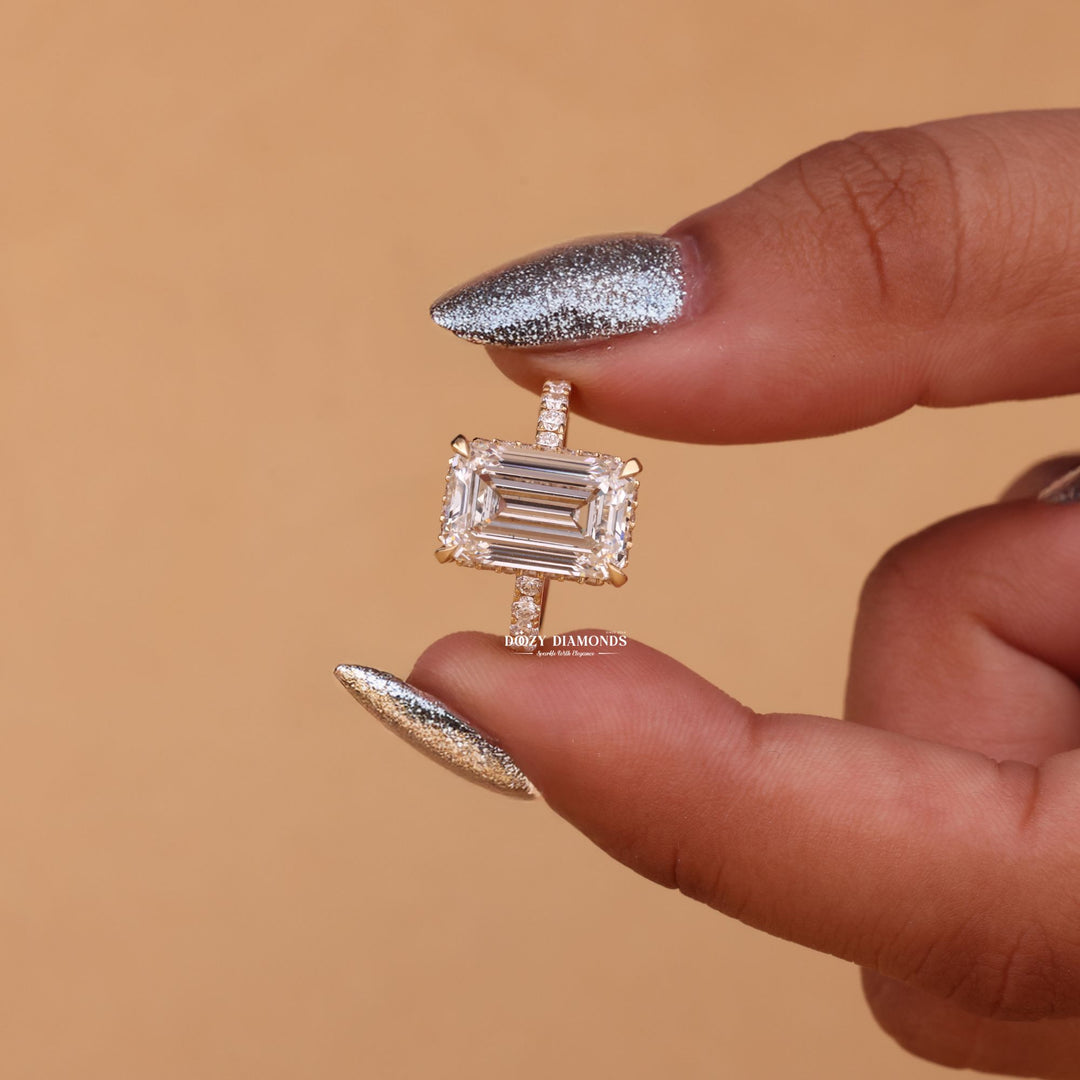 Profile view of emerald cut hidden halo engagement ring band