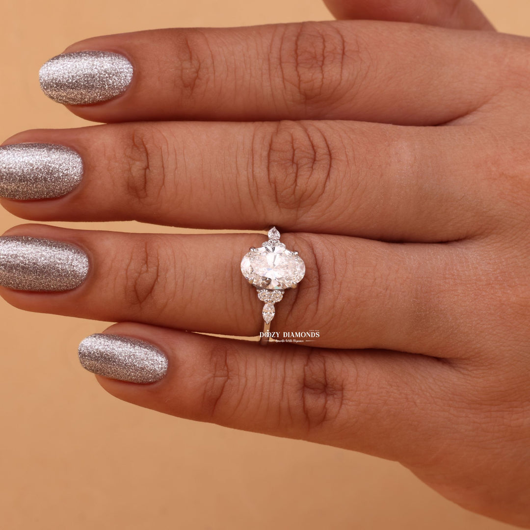 Oval cut cluster engagement ring shown in real-life wear