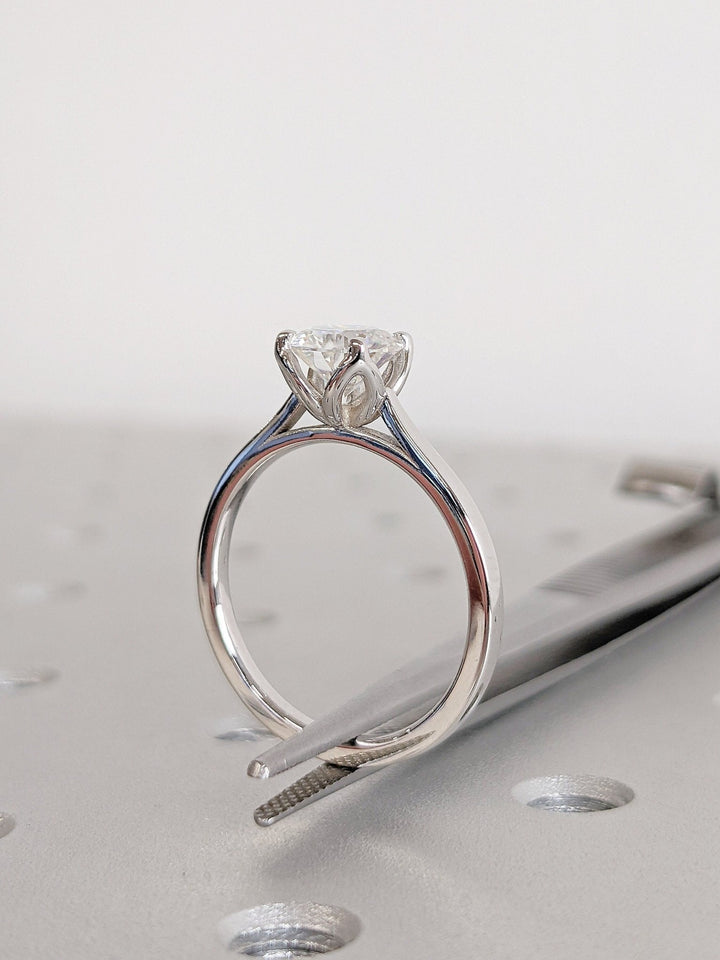 Side angle of round solitaire diamond engagement ring