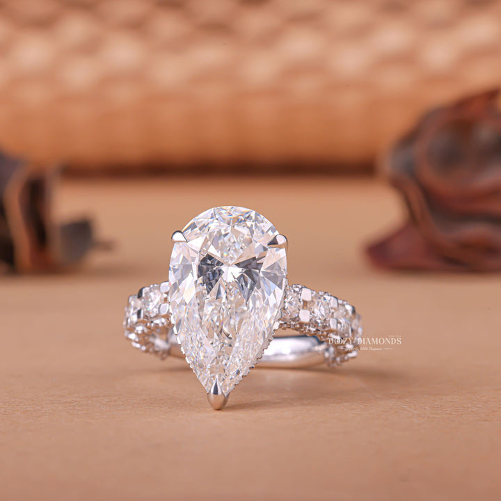 Profile view of pear cut hidden halo engagement ring band