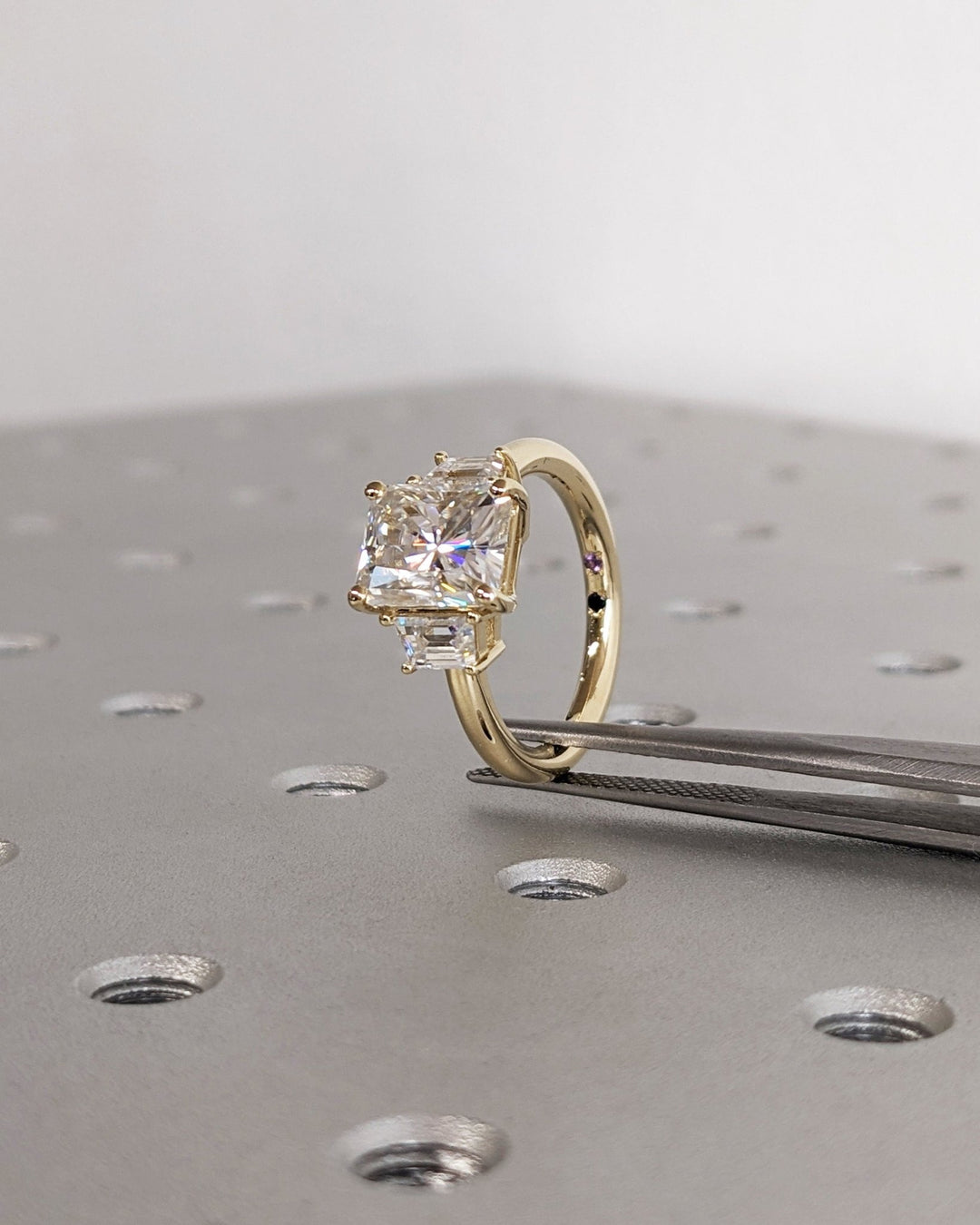 Radiant three stone ring set with an IGI graded diamond