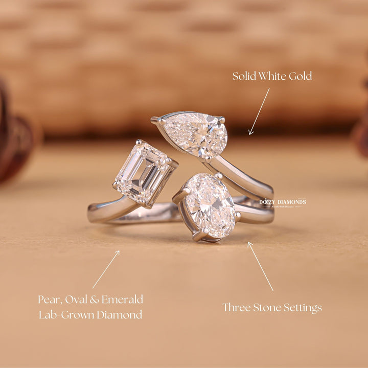 Oval three stone diamond ring displayed on jewelry stand