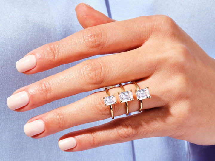 Unboxing view of emerald cut solitaire diamond engagement ring
