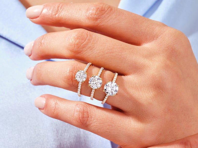 Round pave diamond ring displayed on jewelry stand