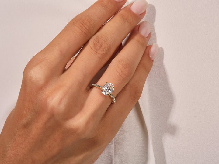 Oval pave engagement ring shown on hand for true-to-life sizing