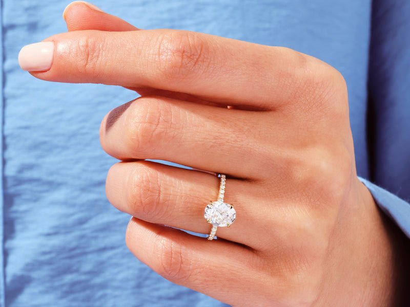 Oval pave engagement ring viewed from the side