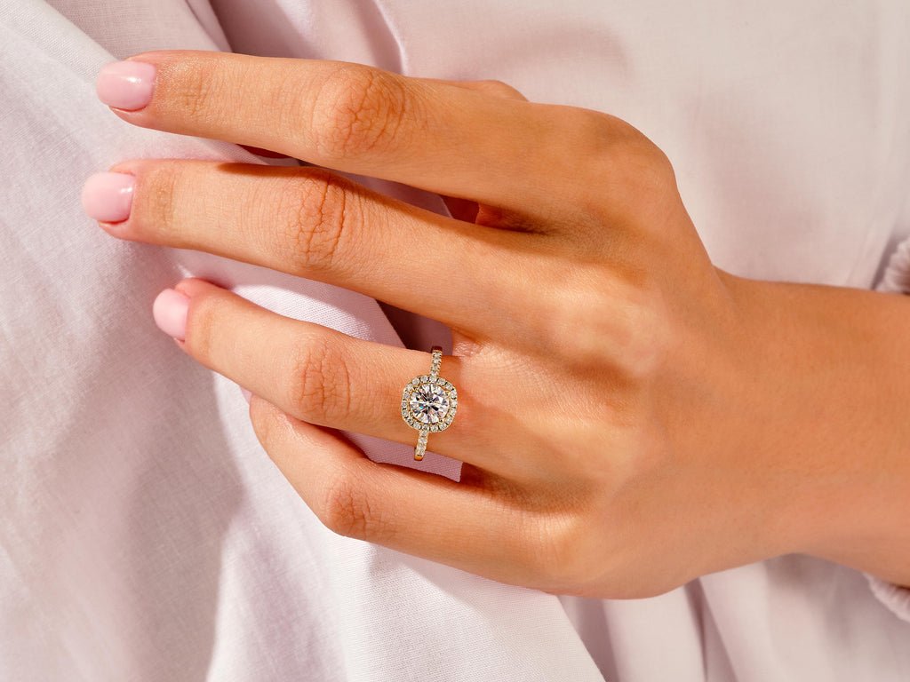 Close-up of round cut center diamond in pave engagement ring