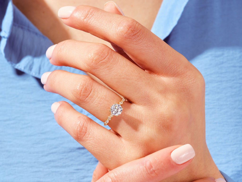 Round milgrain diamond ring presented in signature gift packaging