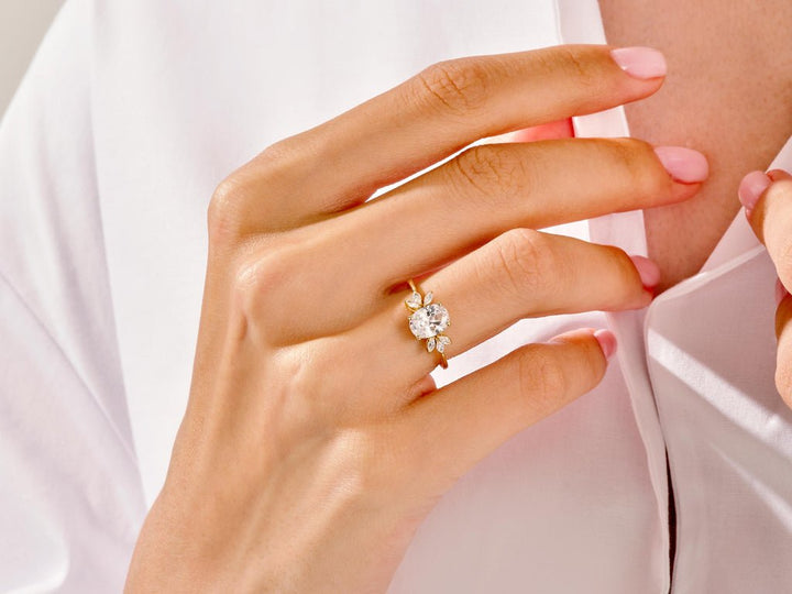 Oval cluster engagement ring viewed from the side