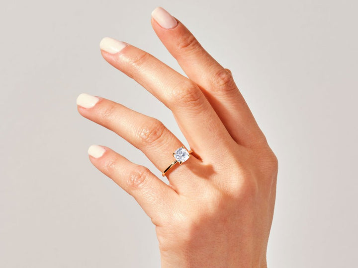 Cushion cut diamond ring worn on hand