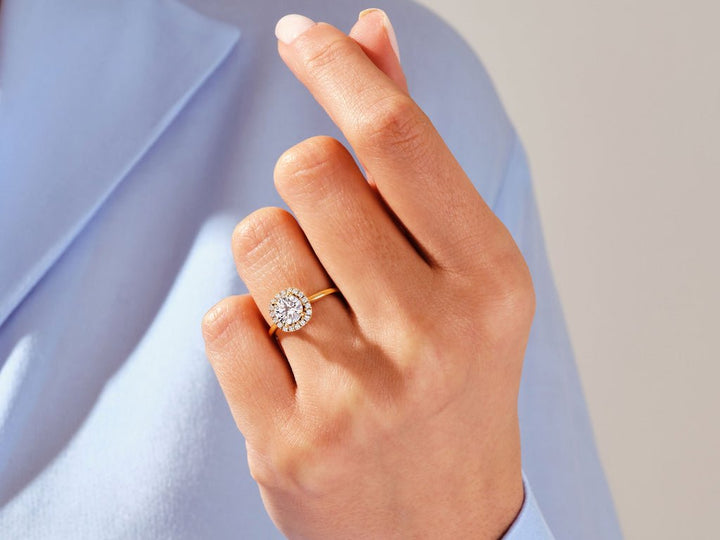 Round halo diamond engagement ring available in multiple metals