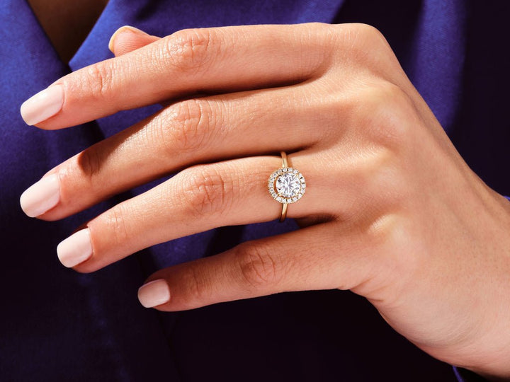 Round cut halo engagement ring with IGI certified center diamond