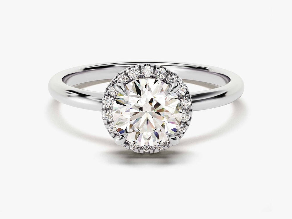 Round halo engagement ring shown on hand for true-to-life sizing