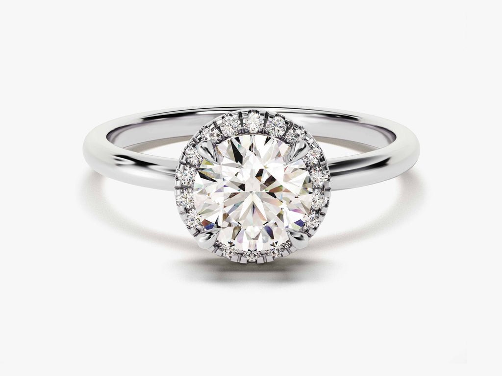 Round halo engagement ring shown on hand for true-to-life sizing
