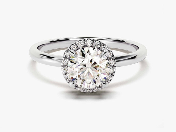 Round halo engagement ring shown on hand for true-to-life sizing