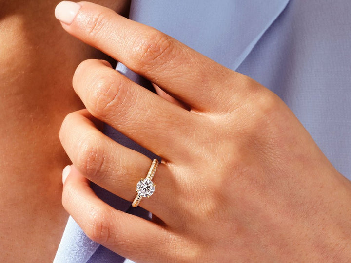Round milgrain diamond engagement ring available in multiple metals