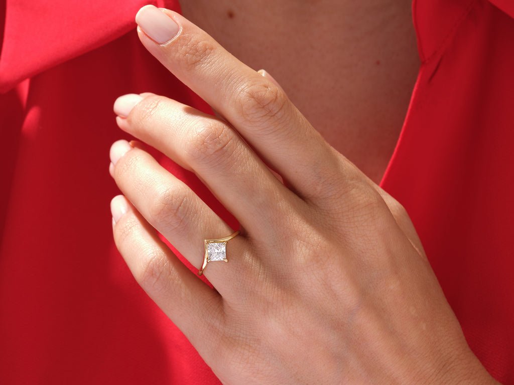 Princess cut engagement ring shown with authenticity certificate