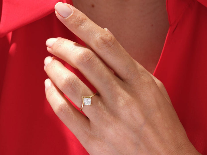 Princess cut engagement ring shown with authenticity certificate