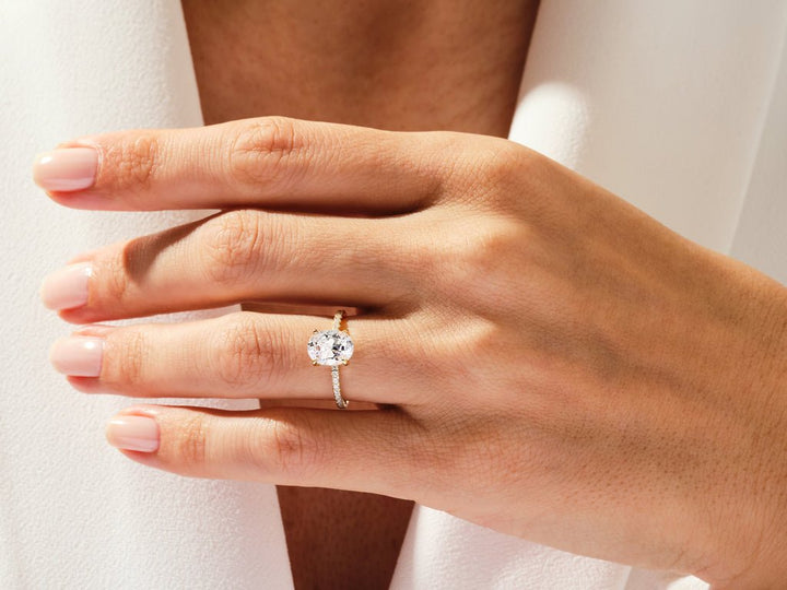 Oval hidden halo lab grown diamond ring side profile in gold setting