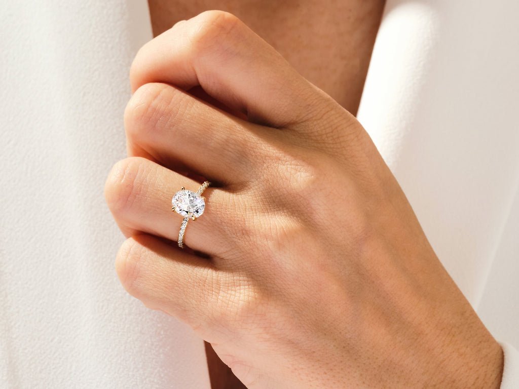 Detailed close-up of oval hidden halo diamond engagement ring