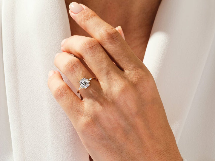Profile view of emerald cut cluster engagement ring band