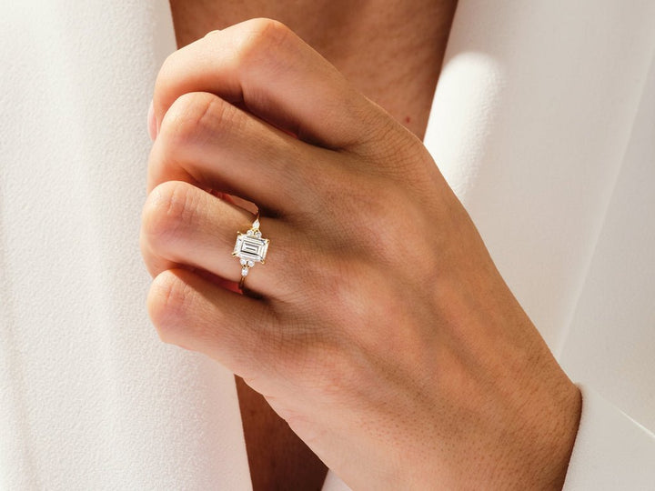 Emerald cut diamond ring worn on hand