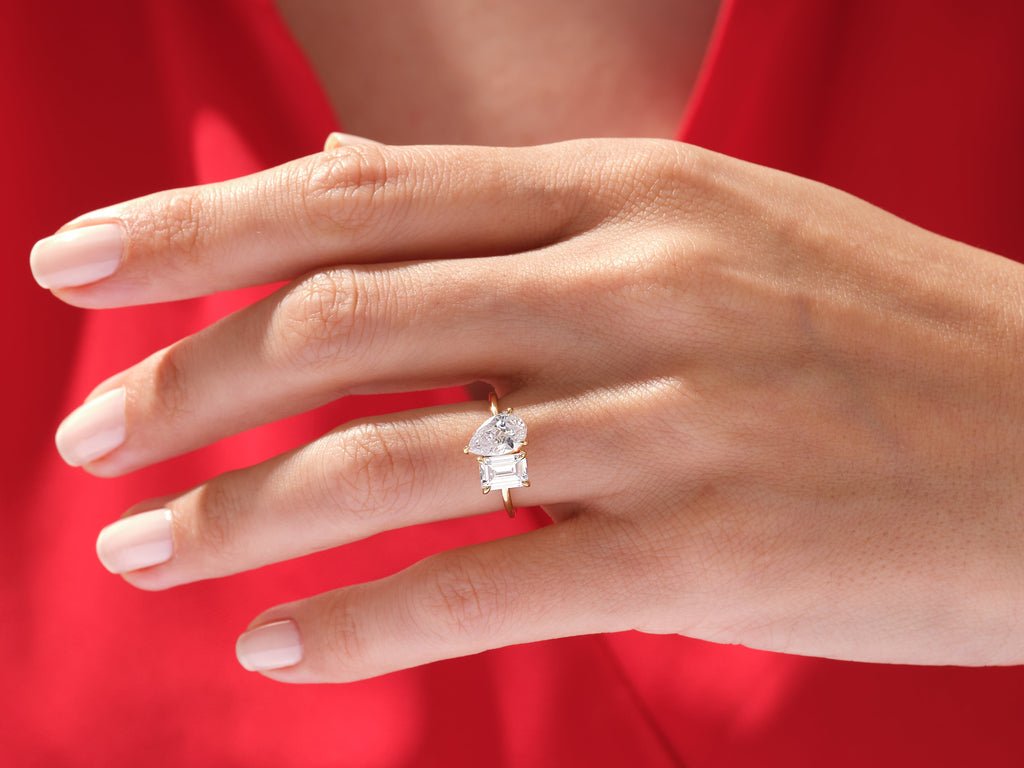 Pear solitaire engagement ring shown on hand for true-to-life sizing