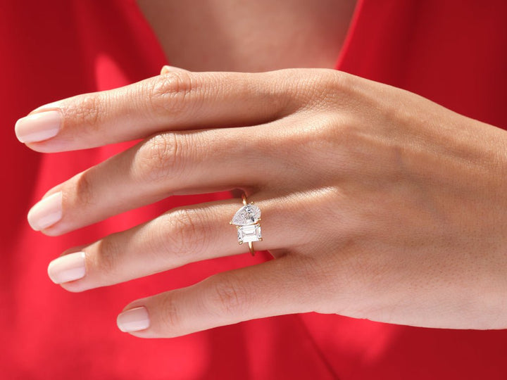 Pear solitaire engagement ring shown on hand for true-to-life sizing