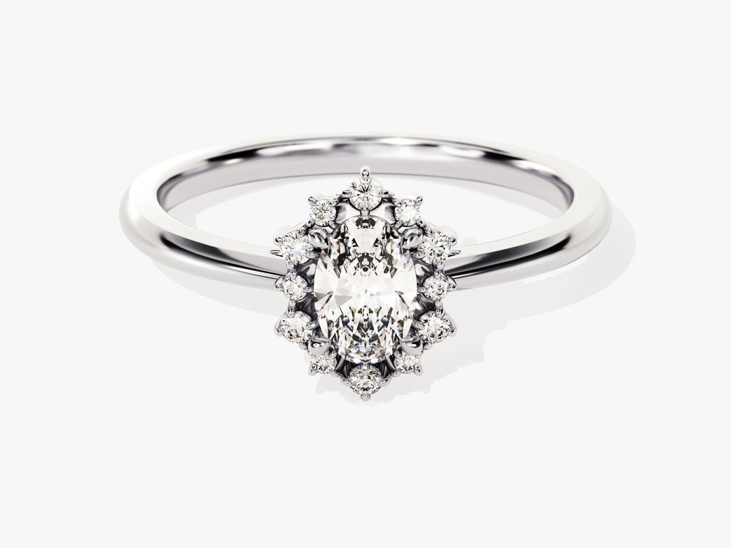 Close-up of oval cut center diamond in cluster engagement ring