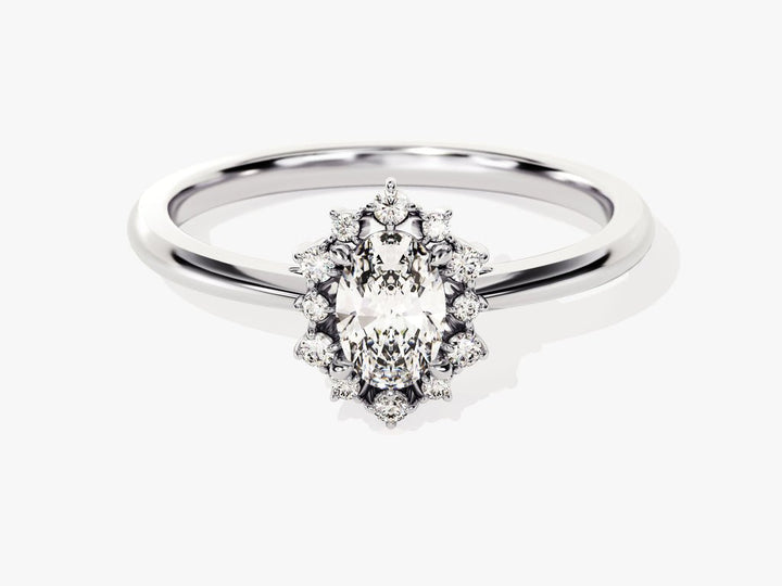 Close-up of oval cut center diamond in cluster engagement ring