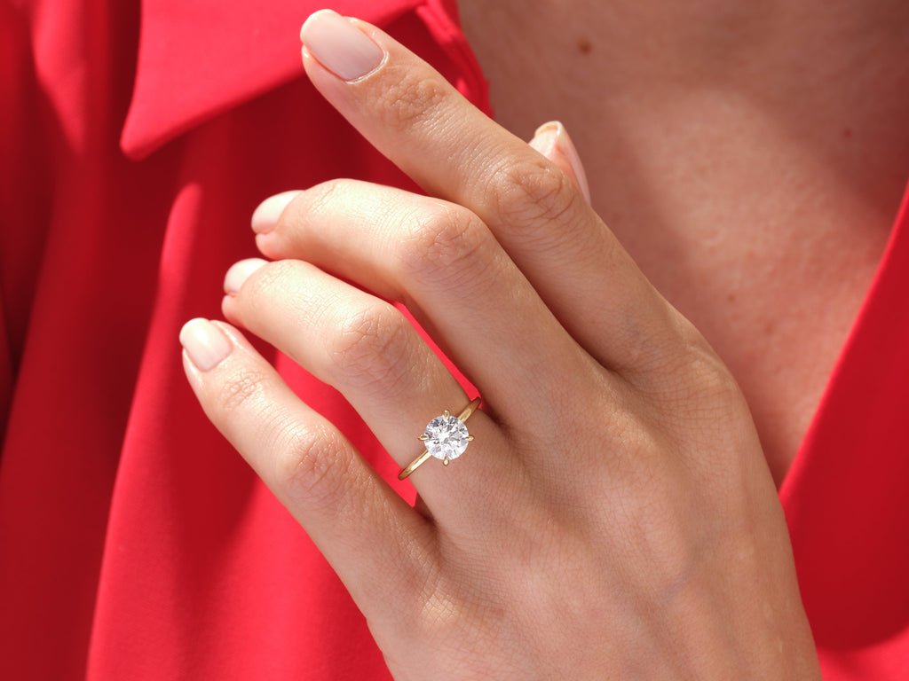 Round hidden halo engagement ring close-up highlighting diamond sparkle