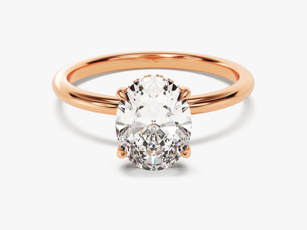 Oval hidden halo diamond ring presented in signature gift packaging