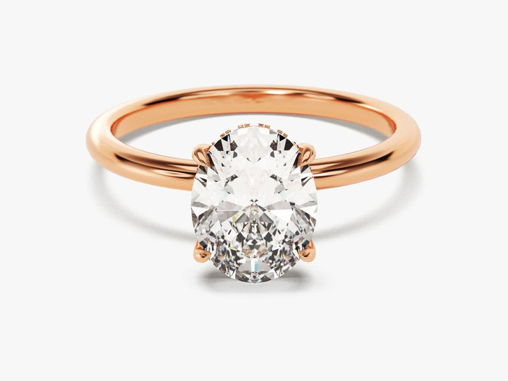 Oval hidden halo diamond ring presented in signature gift packaging