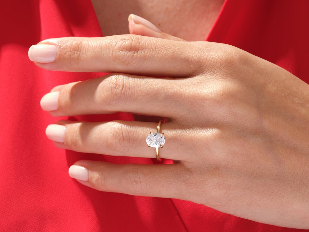 Oval cut engagement ring shown with authenticity certificate