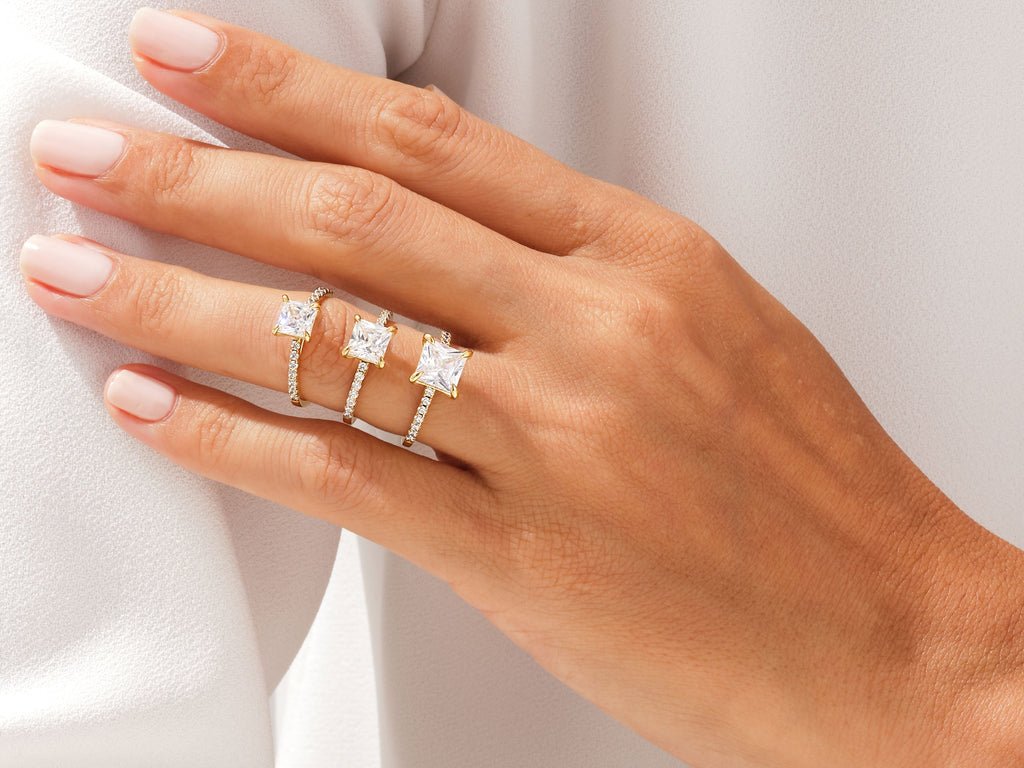 Close-up of princess cut center diamond in pave engagement ring